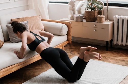 A woman stretches on a mat in a stylish living room, promoting a healthy lifestyle.
